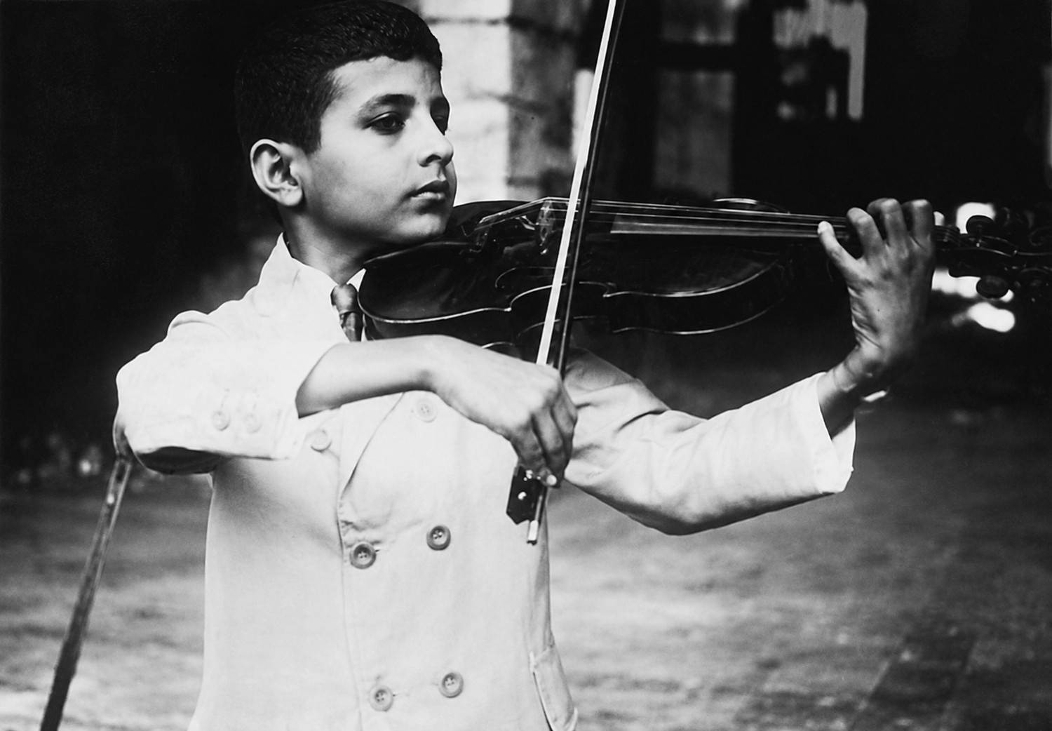 nanibhoy playing violin at a parsi wedding